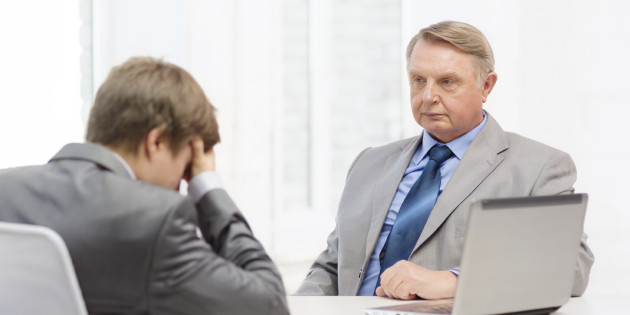 older man and young man having argument in office